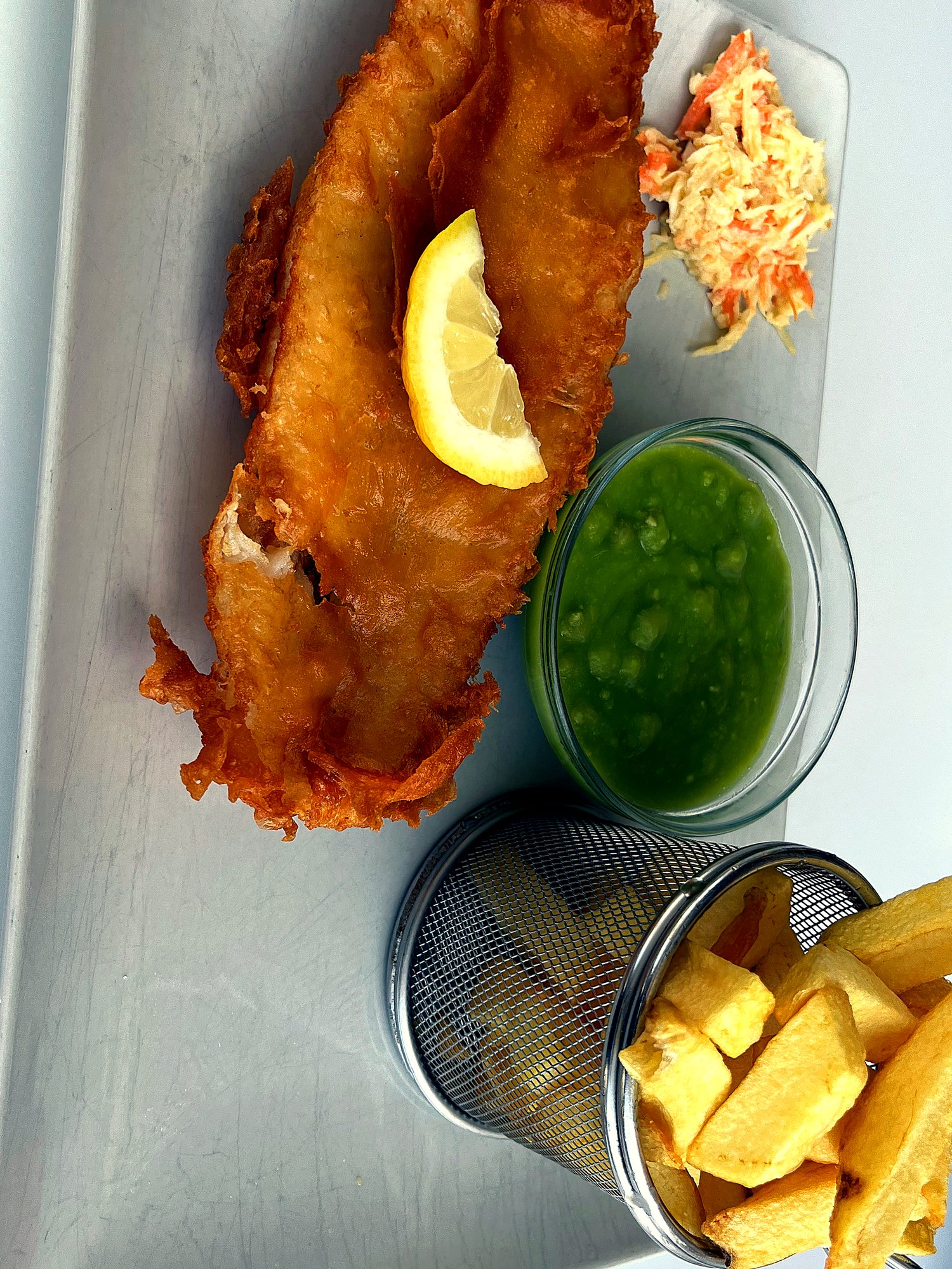 Hand-battered cod & chips with mushy peas, coleslaw and lemon